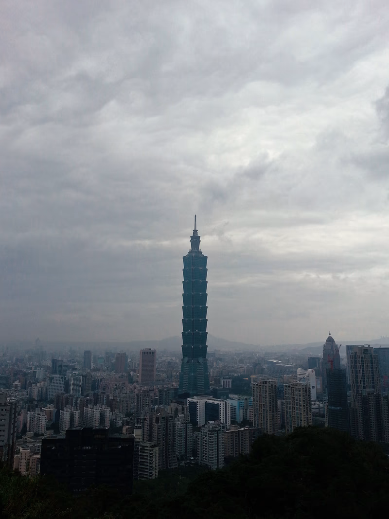 A photo of Taipei's iconic Taipei 101 building under a cloudy sky